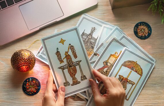Une table lumineuse avec un jeu de tarot étalé, des cartes représentant des symboles